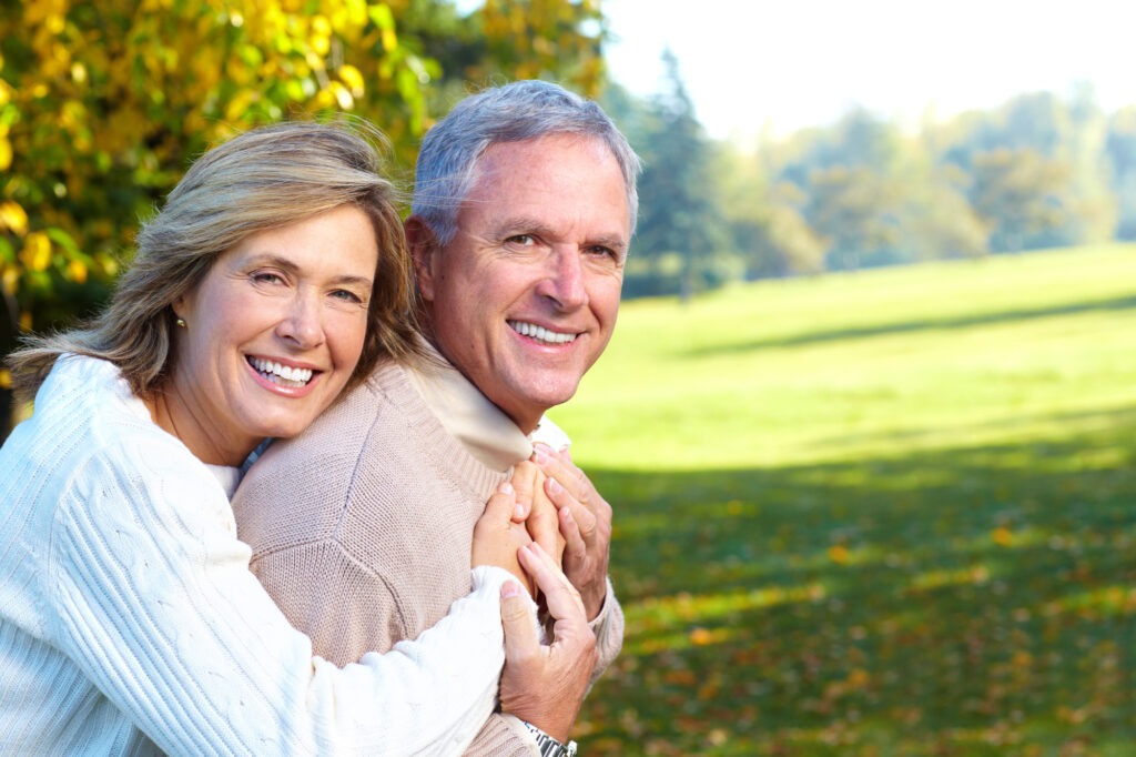 Portrait of Ahappy Elderly Seniors Couple in Park. Golden Age. Amusing Old Couple on Vacation